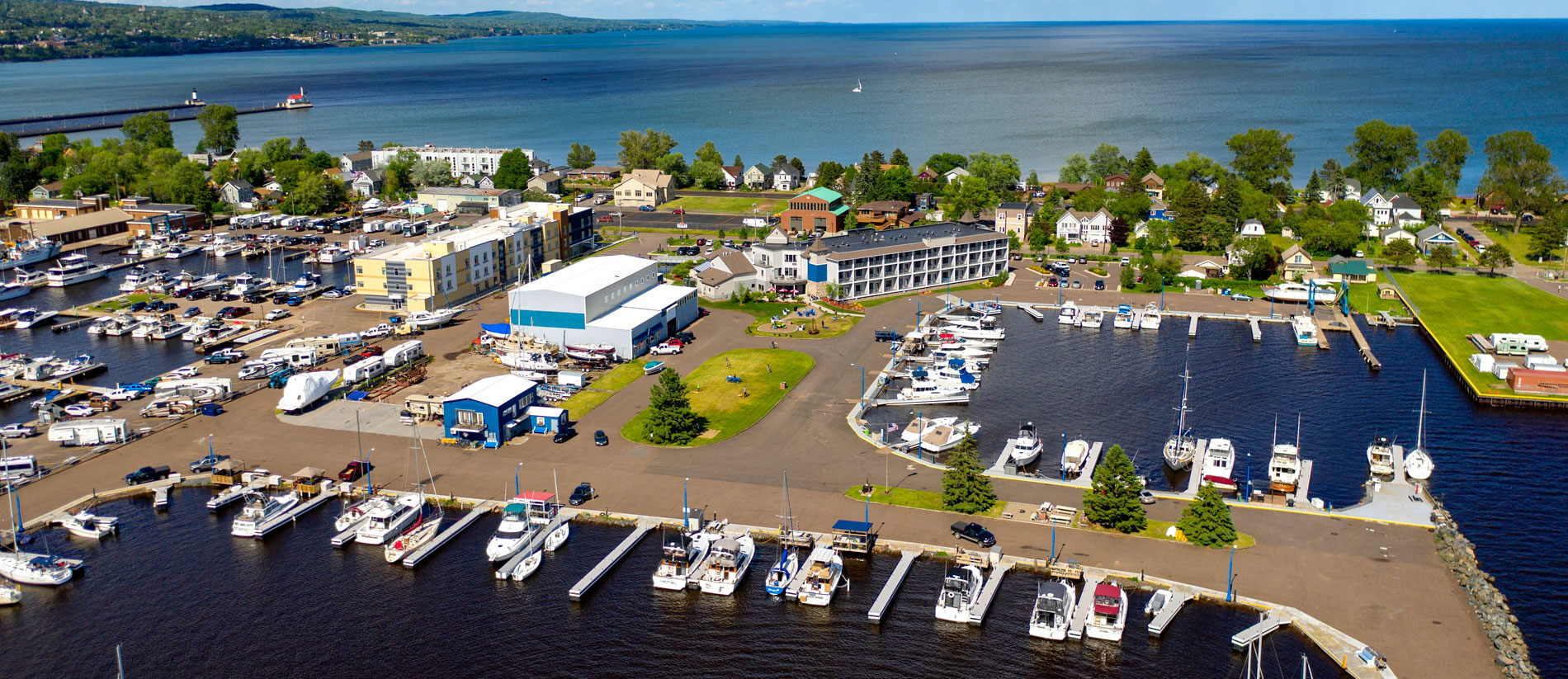 the overlook of Park Point Marina Inn and its shore full of pleasure boats taking from the sky