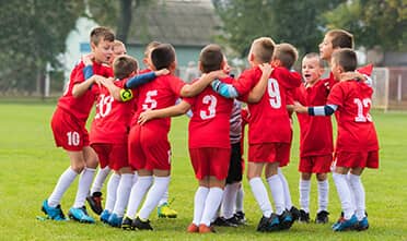 children's soccer team celebrates after a victory