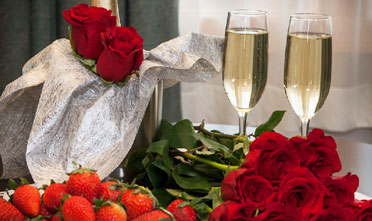 strawberries, roses and two glasses of champagne wait  for guest's of Park Point Marina Inn's romance package.